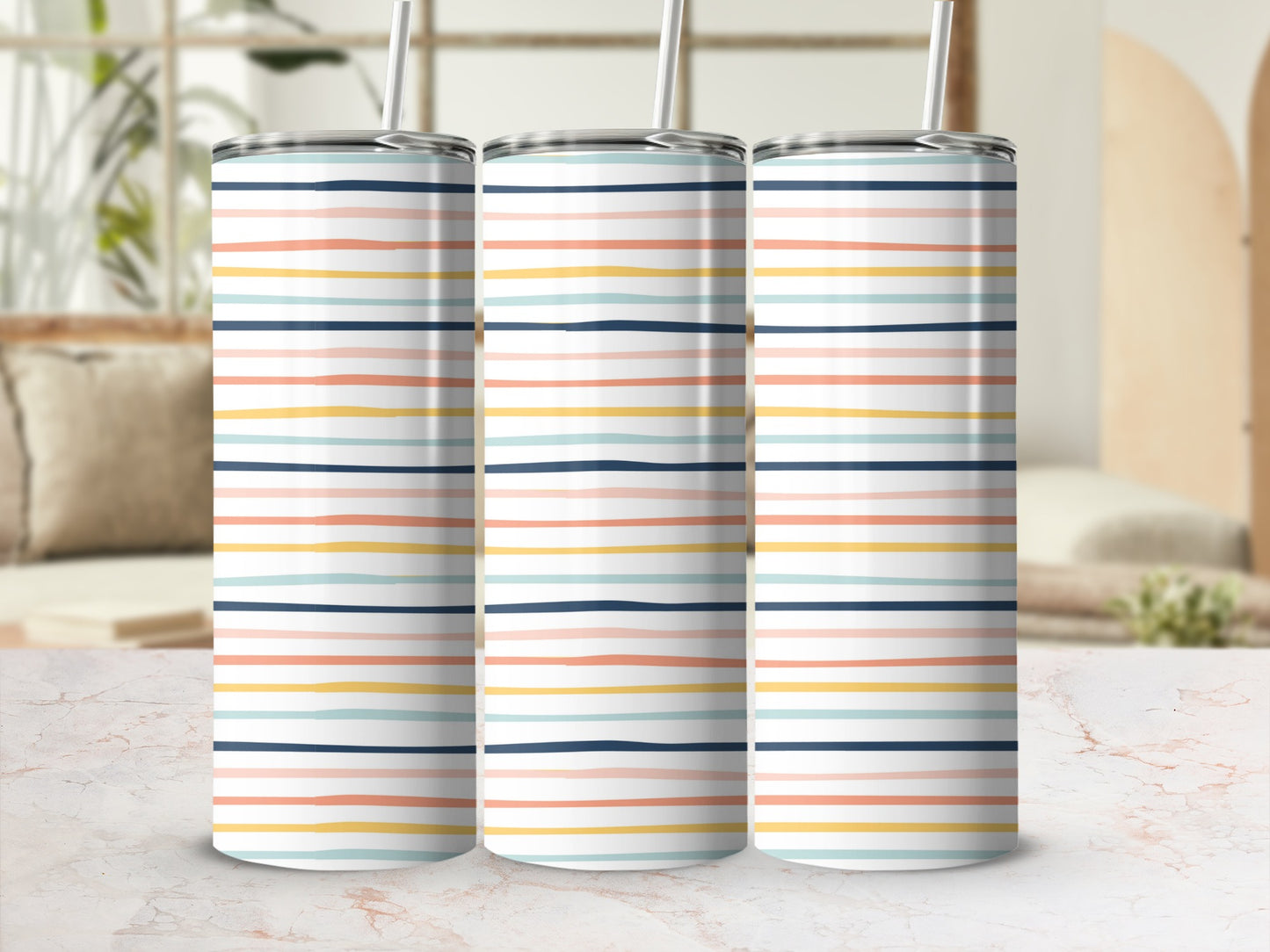 Three tall tumblers with thin pastel stripes on a marble surface.