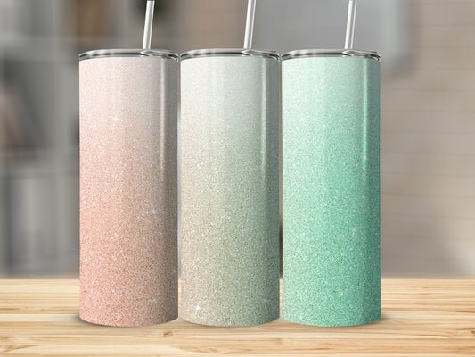 Three glitter tumblers in rose gold, beige, and mint green on a wooden surface.