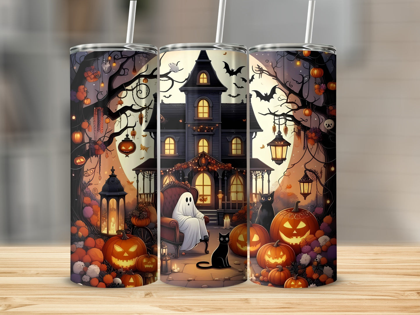 Three tumblers with Halloween artwork featuring a haunted house, ghost, black cats, and pumpkins.