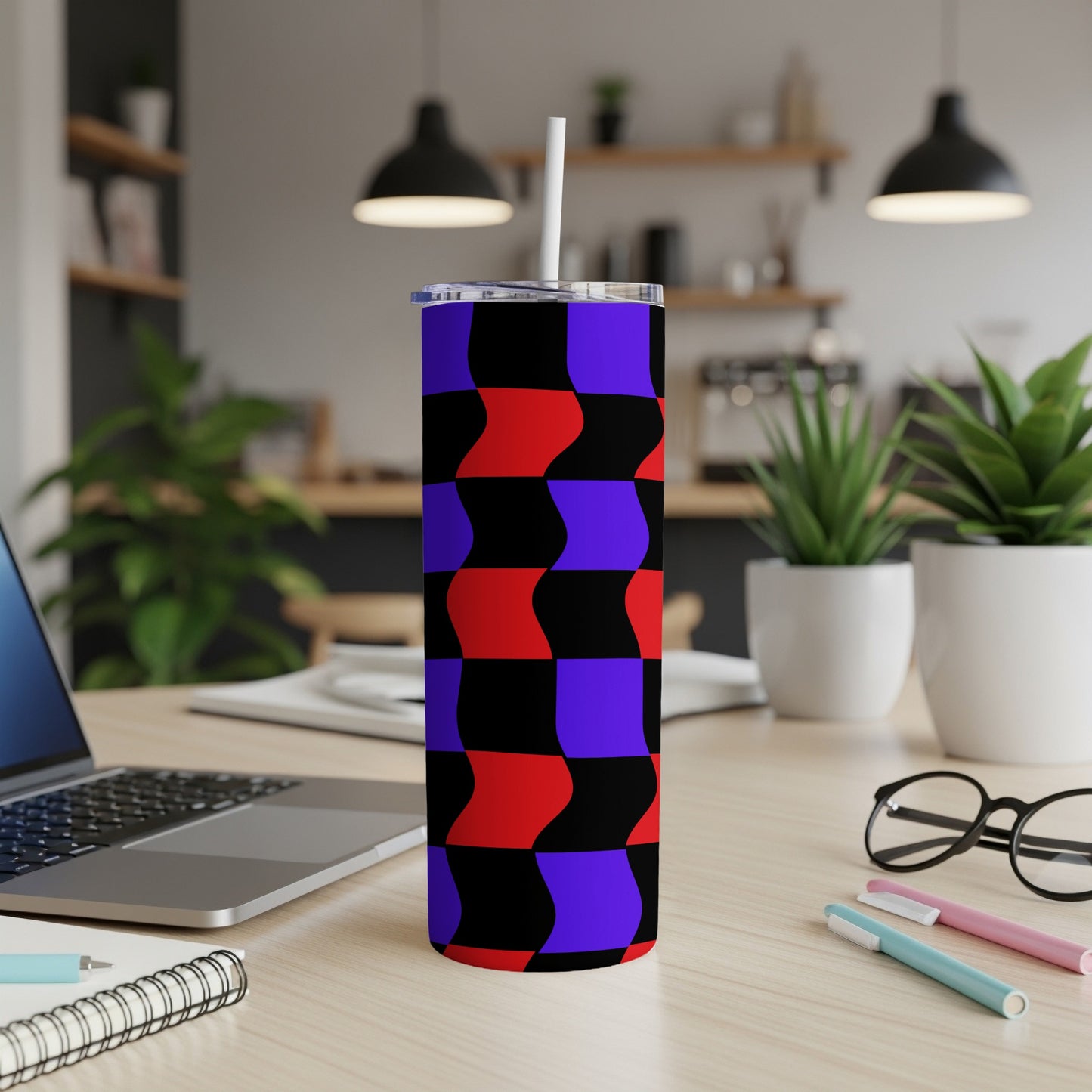 Black, red, and blue wavy geometric pattern on a skinny tumbler with straw.