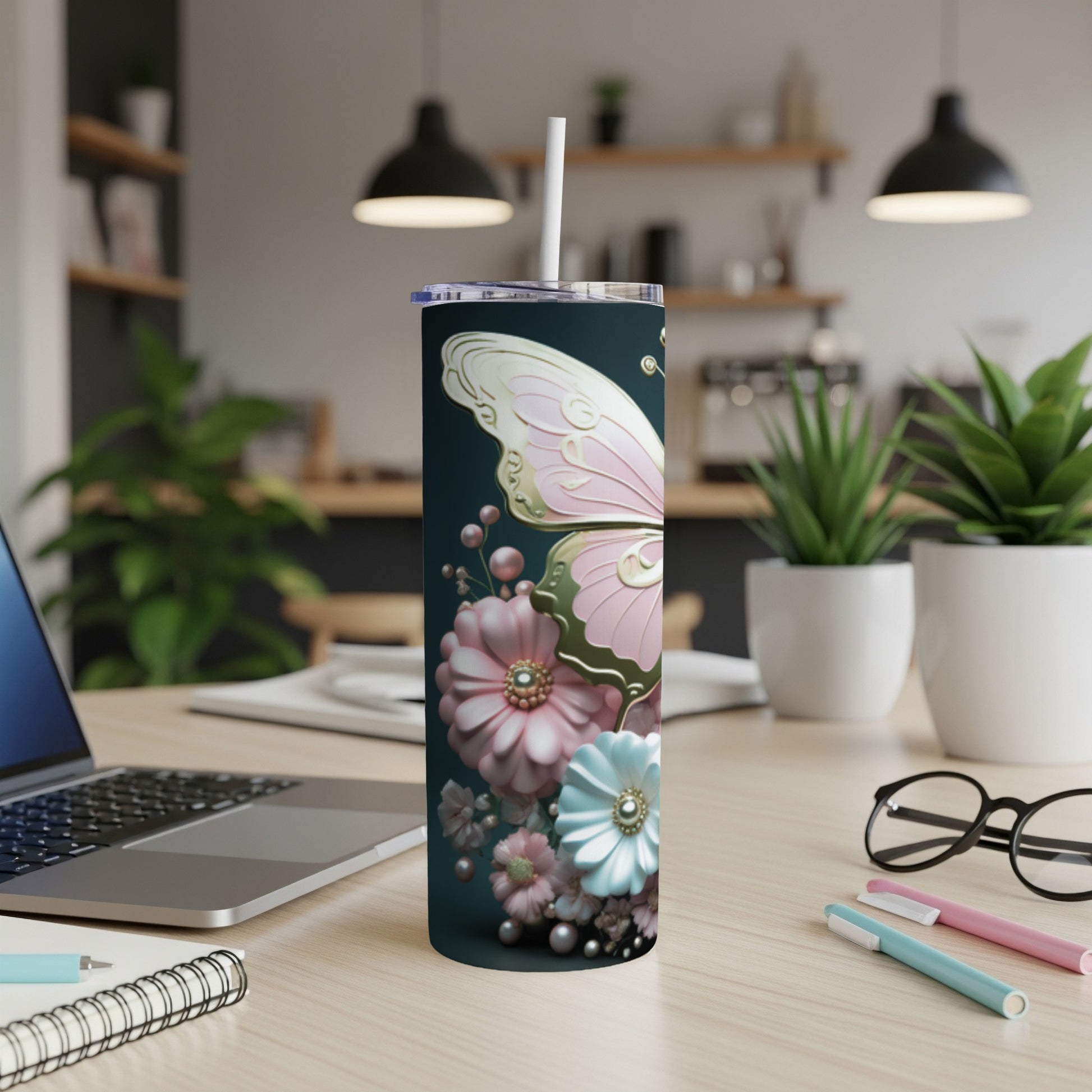 Pink butterfly and flowers on a dark green skinny tumbler with a white straw.