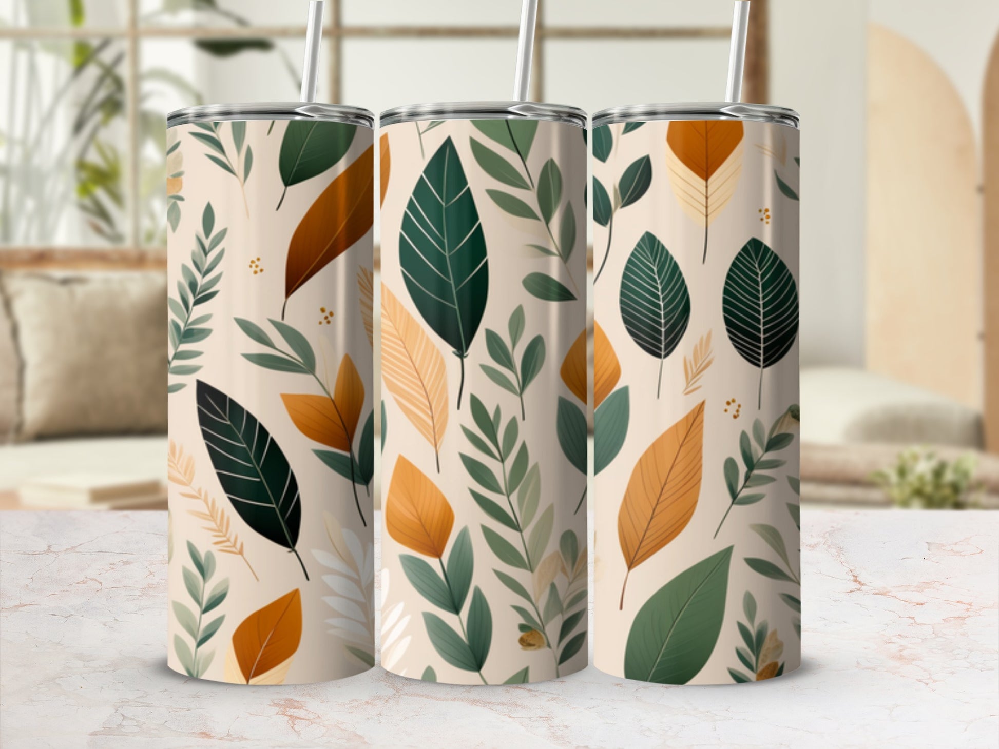 Three tumblers with a repeating pattern of beige, green, and orange leaves.