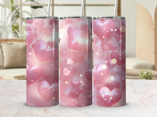 Pink heart pattern on three tumblers with straws.