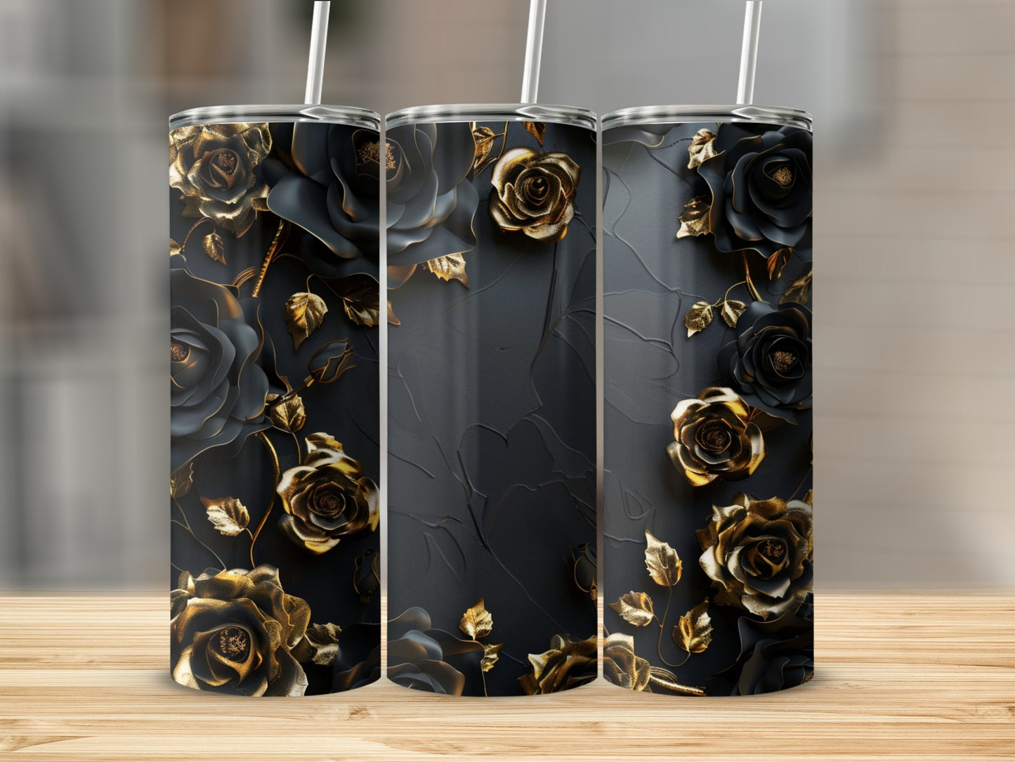 Three black tumblers with gold rose and leaf designs.