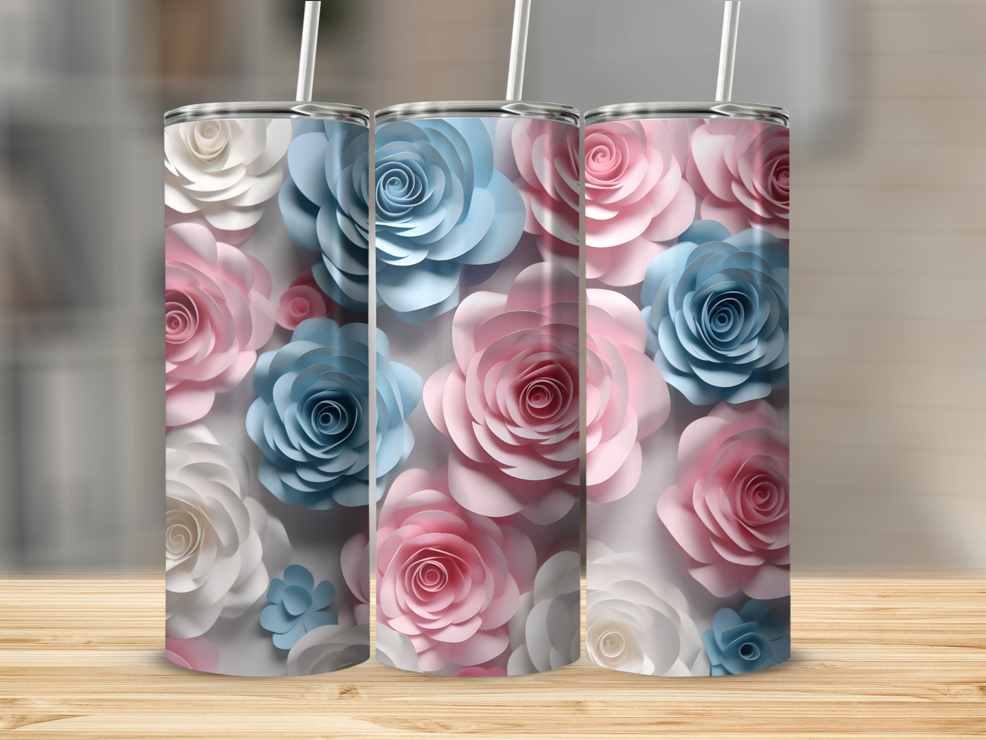 Three tumblers with a floral pattern of pink, blue, and white paper roses.