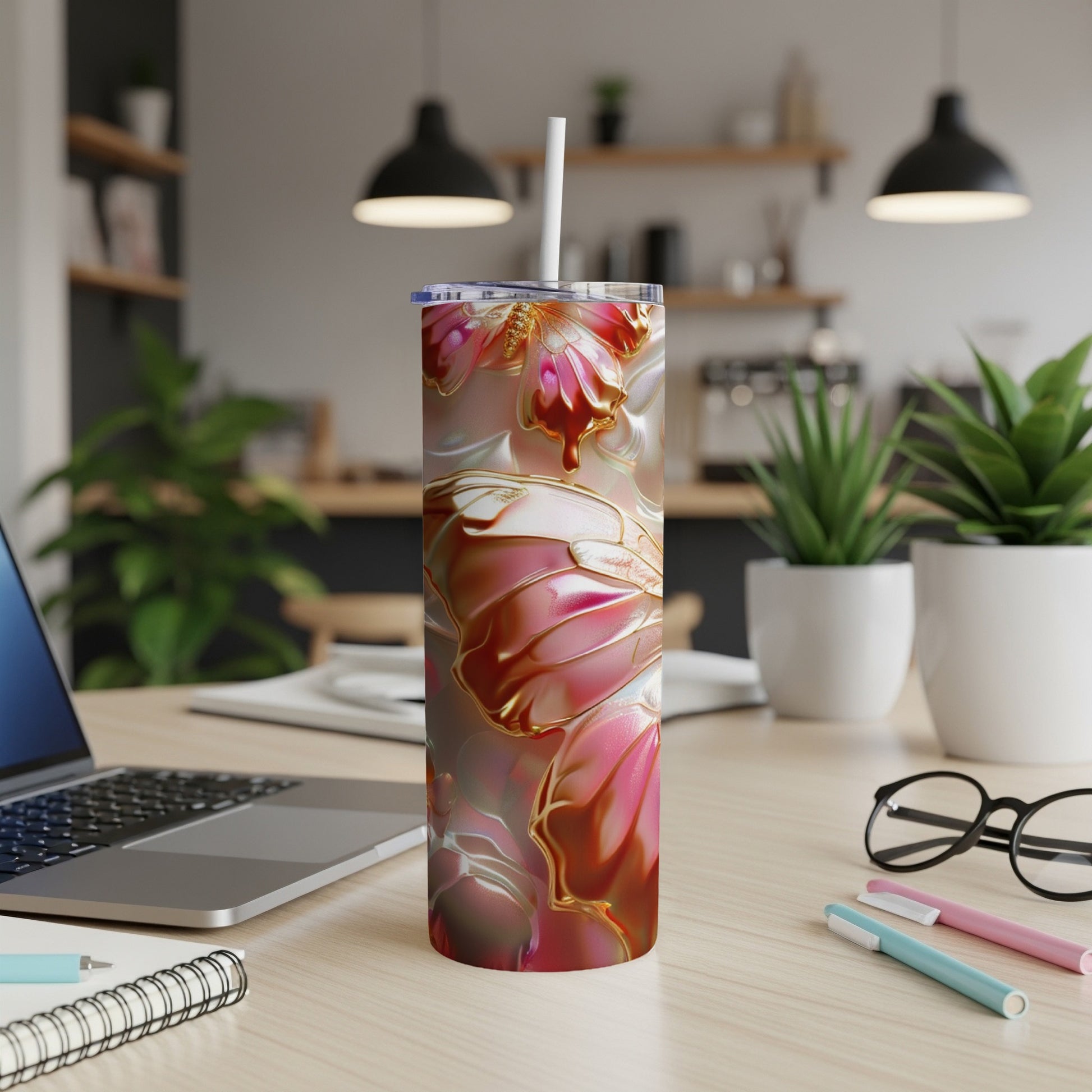 Pink and gold butterfly pattern on a tall tumbler with a white straw.