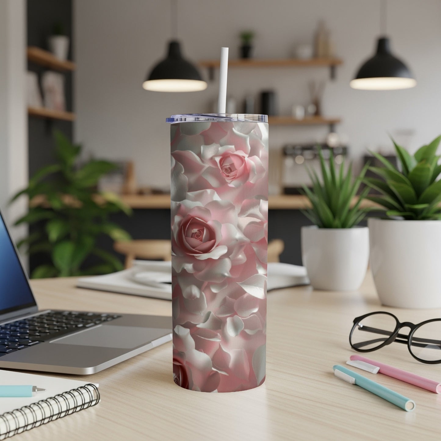 Pink roses bloom across a white insulated tumbler with a straw.