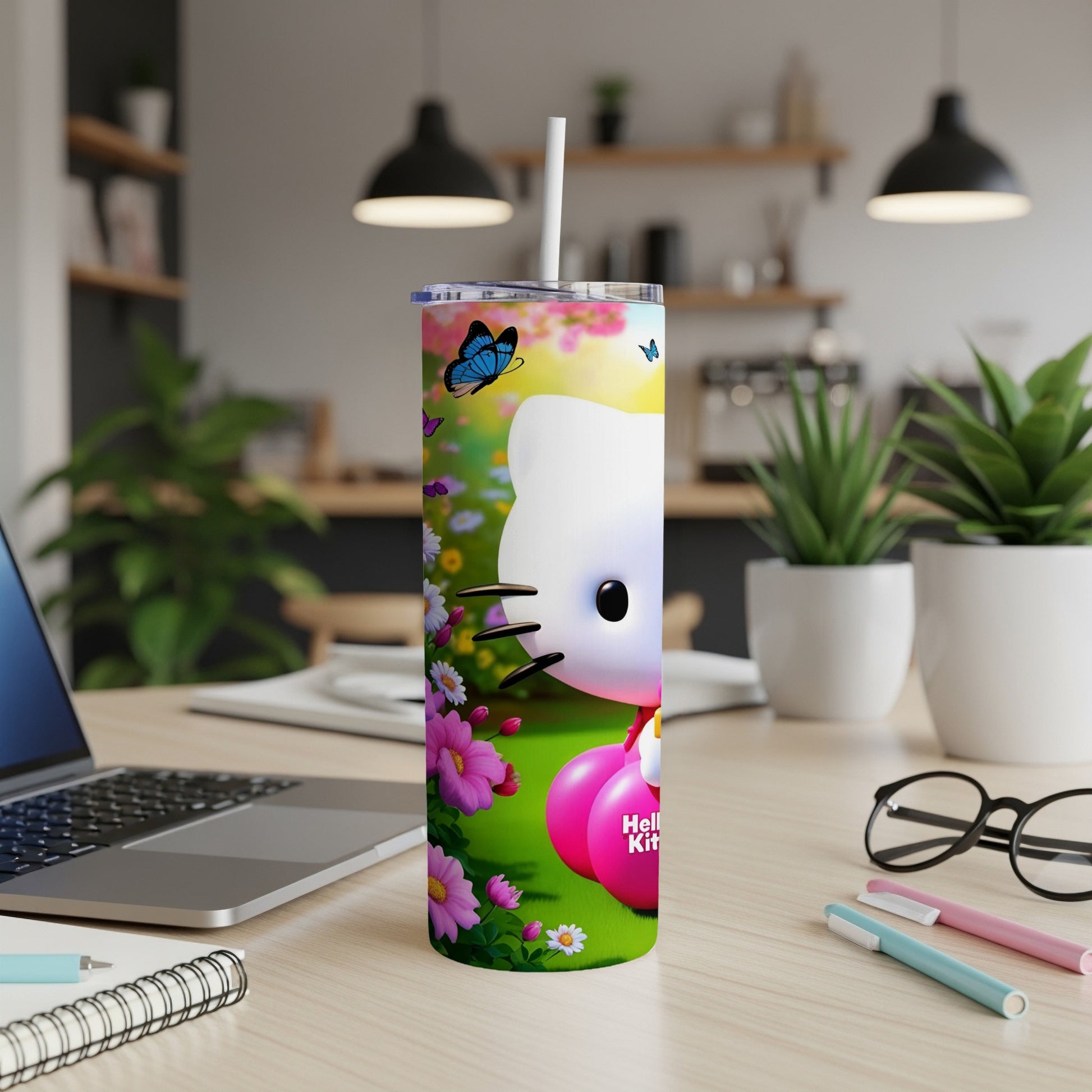 Hello Kitty tumbler with butterflies and flowers on a desk.