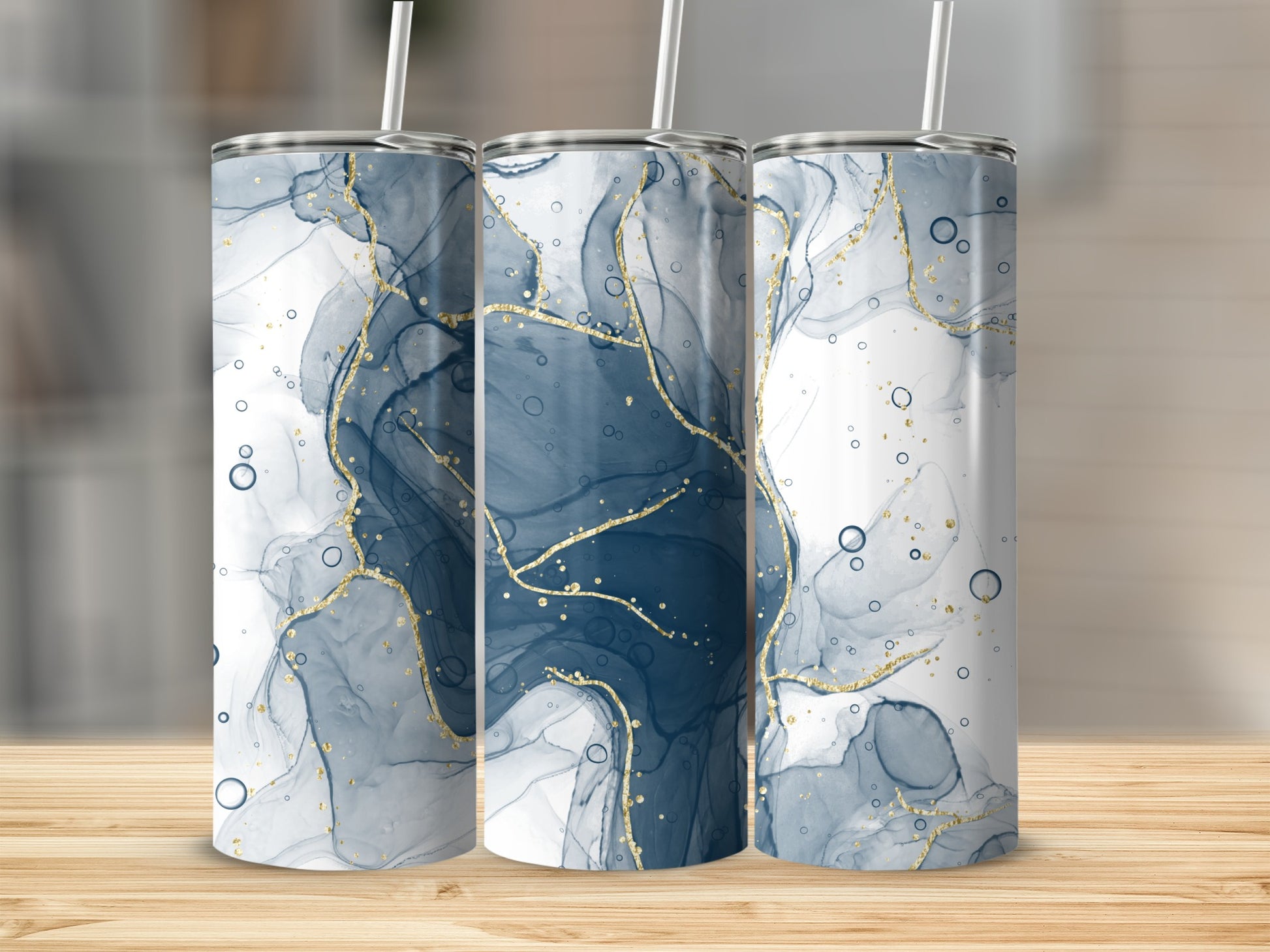 Three tall tumblers with abstract blue and gold marble design.