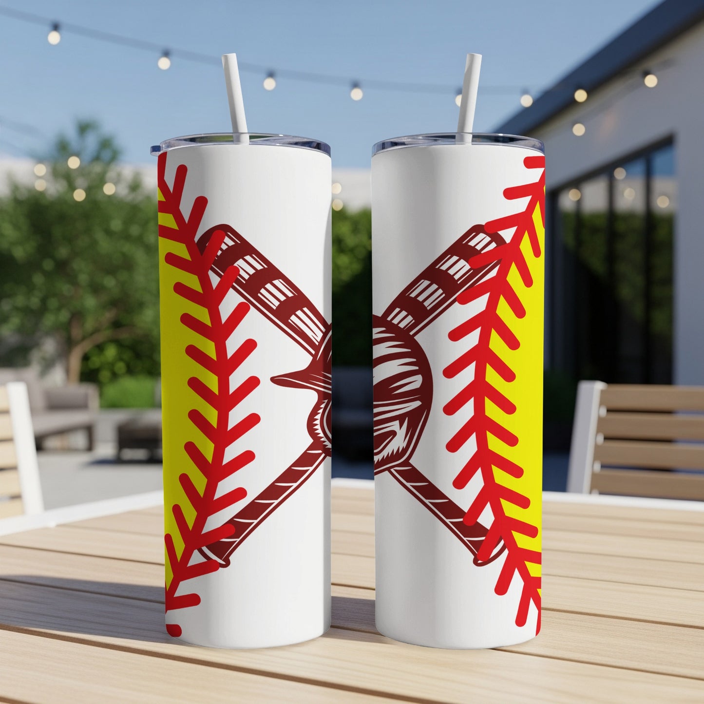 Two white tumblers with softball graphic design on a table.