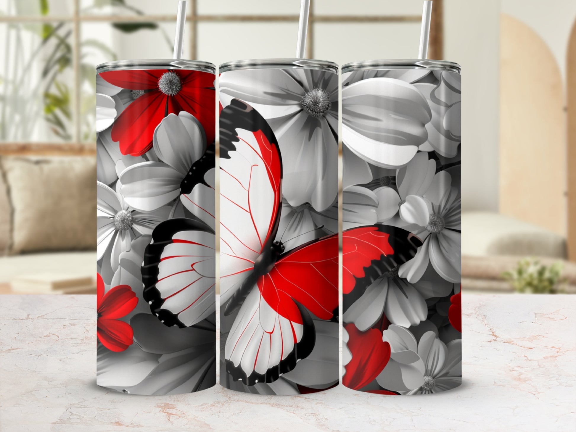 Three tumblers with red and white butterflies and floral designs.