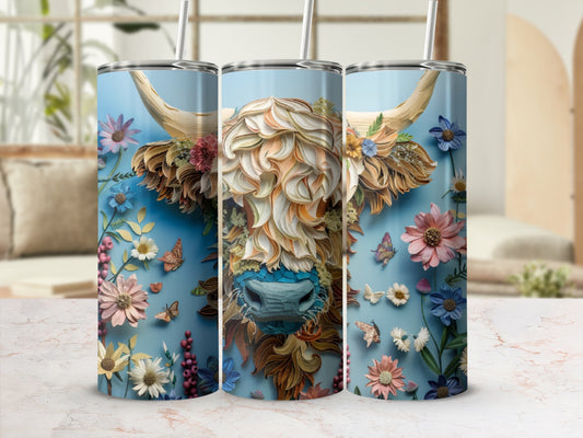 Tall tumbler with floral Highland cow design and blue straw.