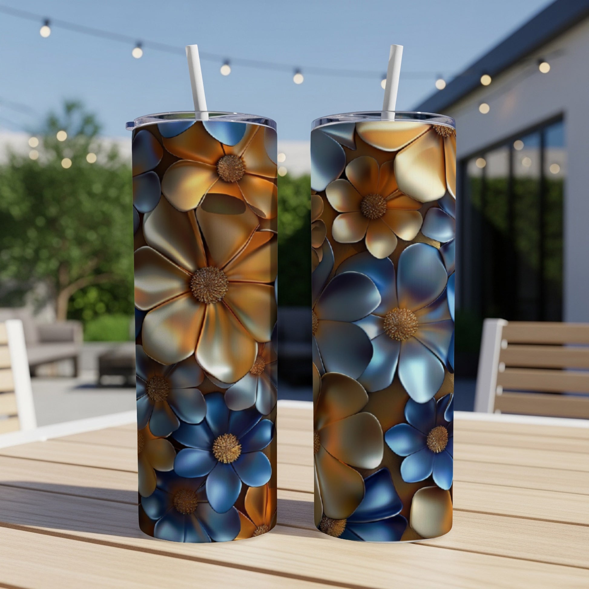 Two tall, metallic tumblers with floral patterns stand on a wooden table.