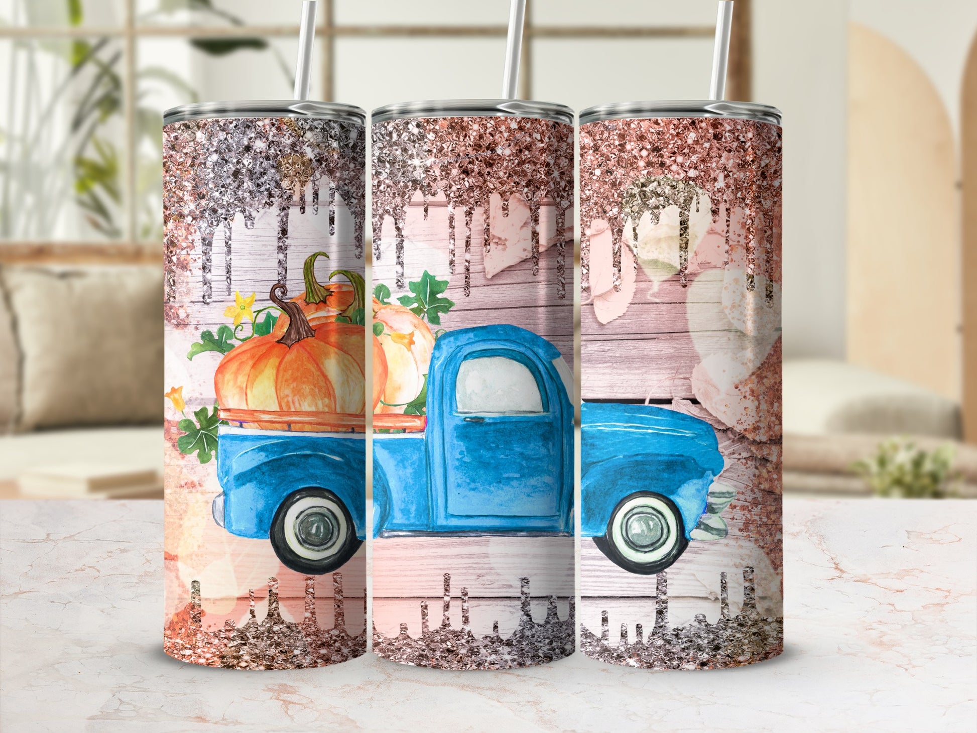 Blue truck with pumpkins on a glittery tumbler design.