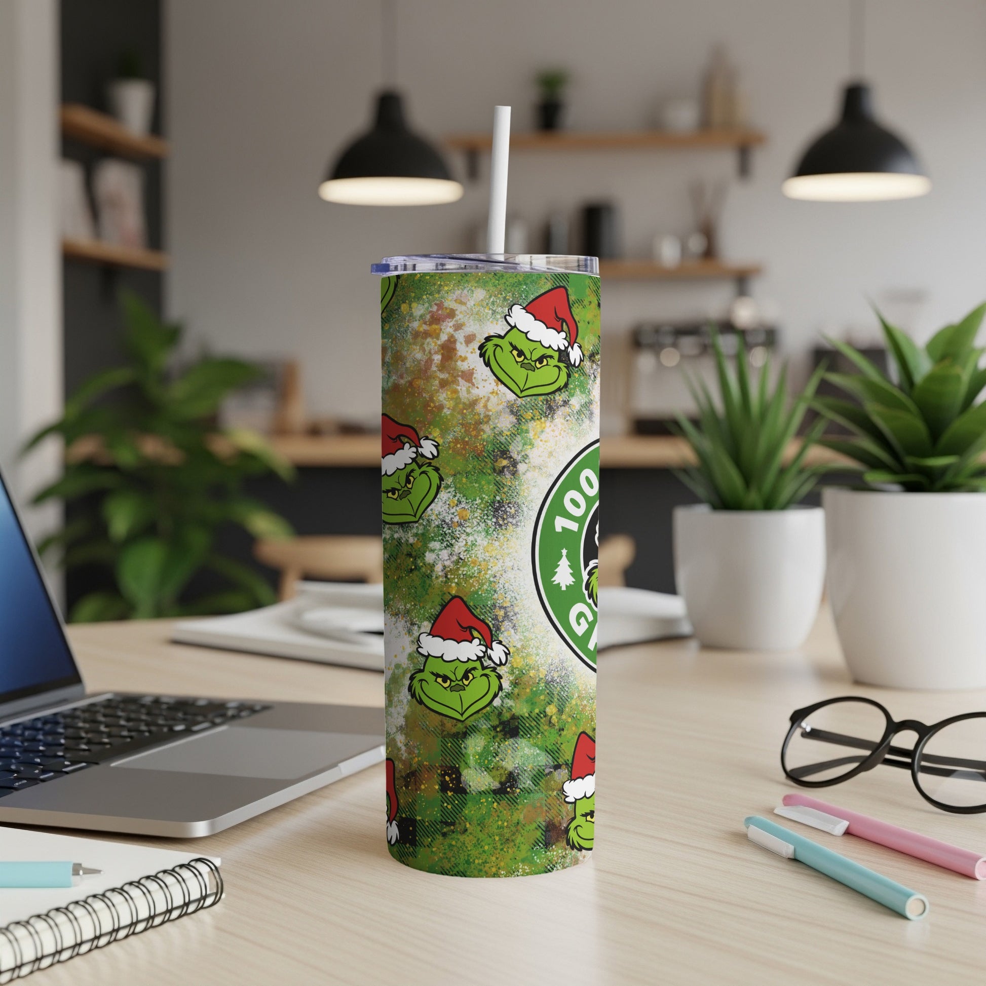 Green Grinch faces and Starbucks logo pattern on a white tumbler with straw.