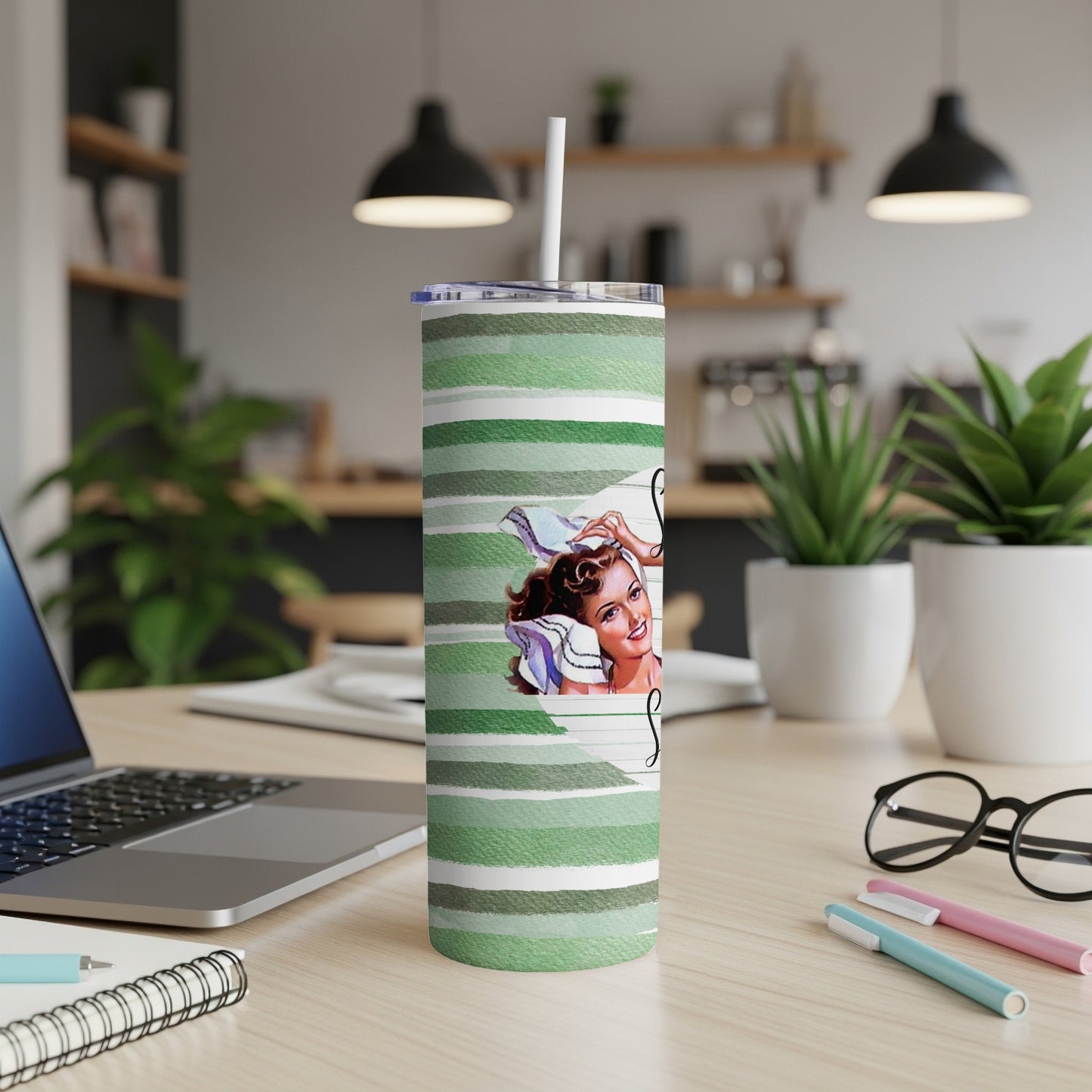Green striped tumbler with a retro woman's face and straw.
