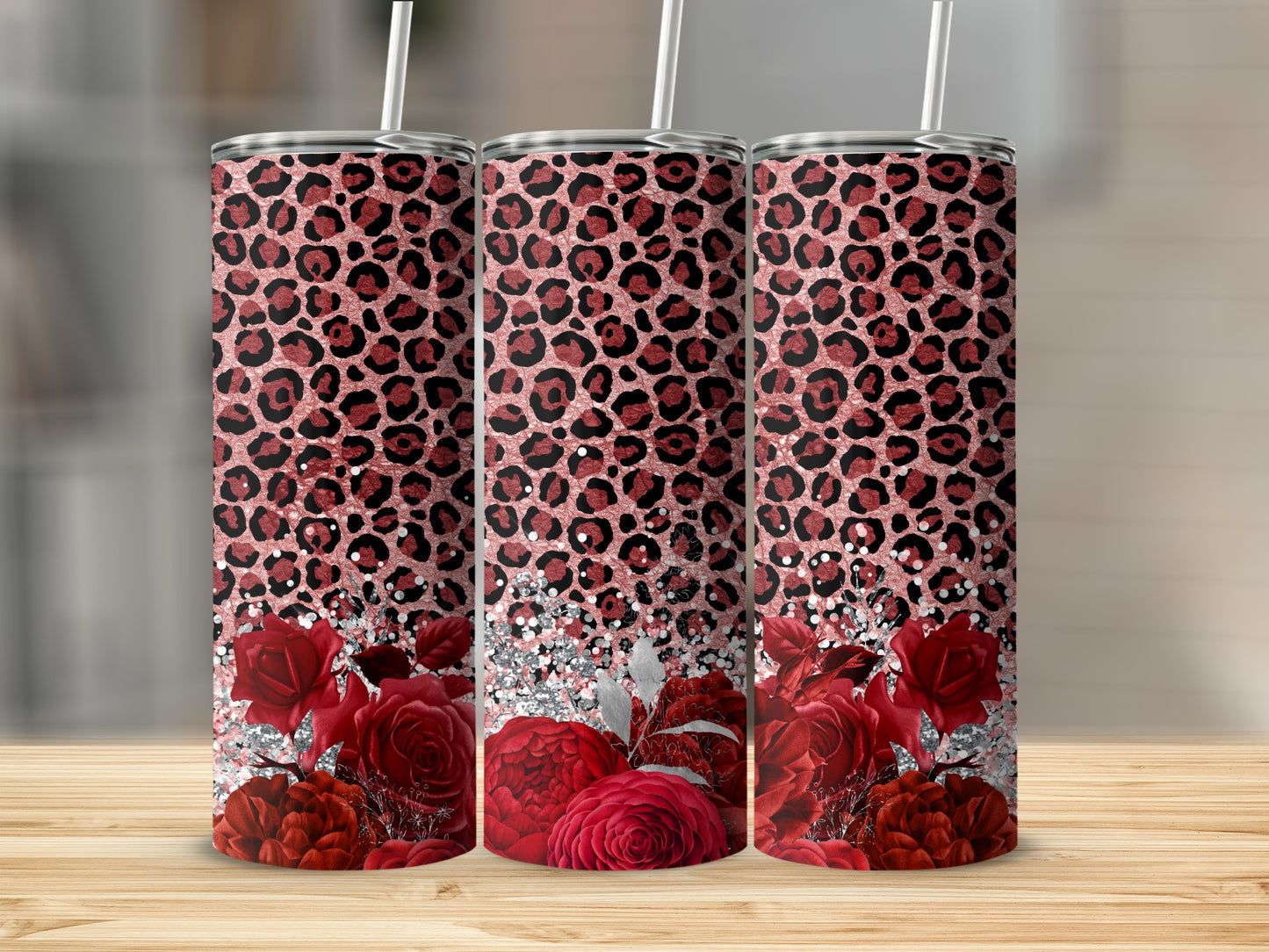 Three tall tumblers with leopard print and red rose designs.