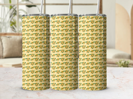 Three tumblers with a yellow sunflower pattern on a marble countertop.