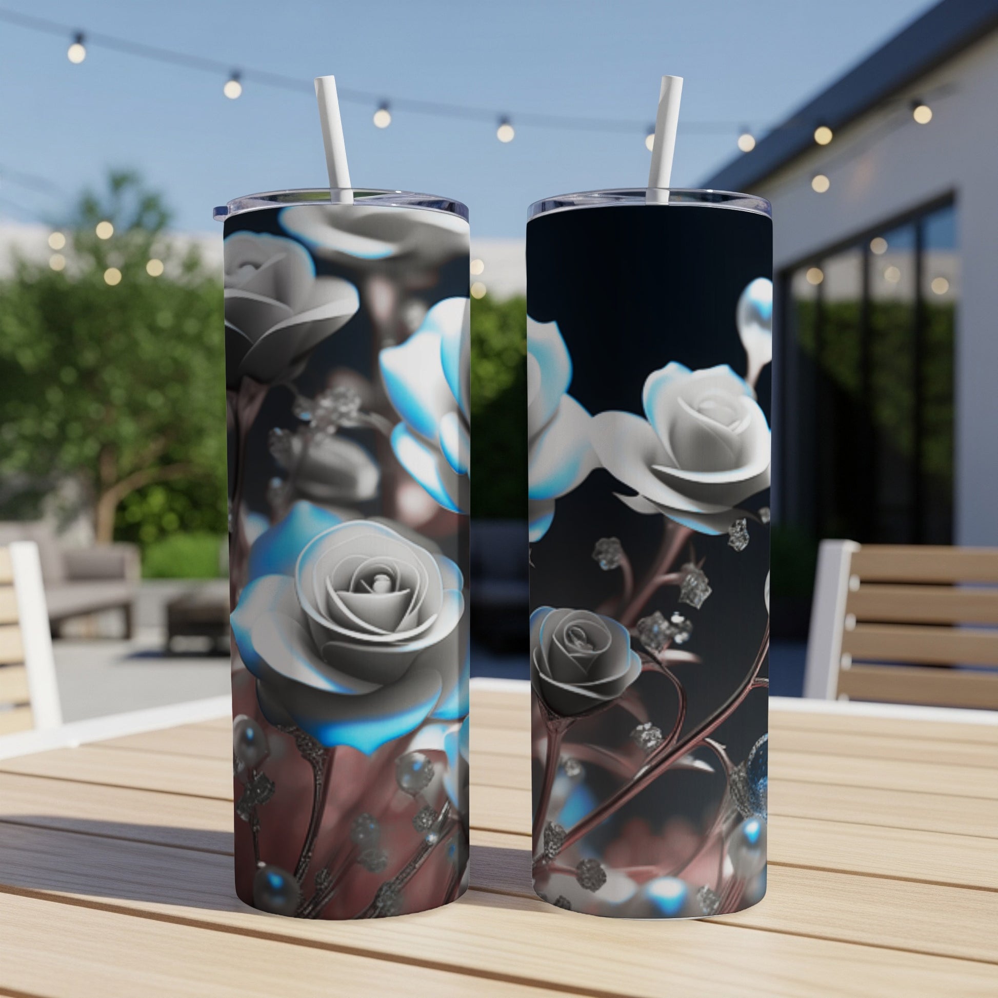 Two tall tumblers with a white rose design sit on a wooden table.
