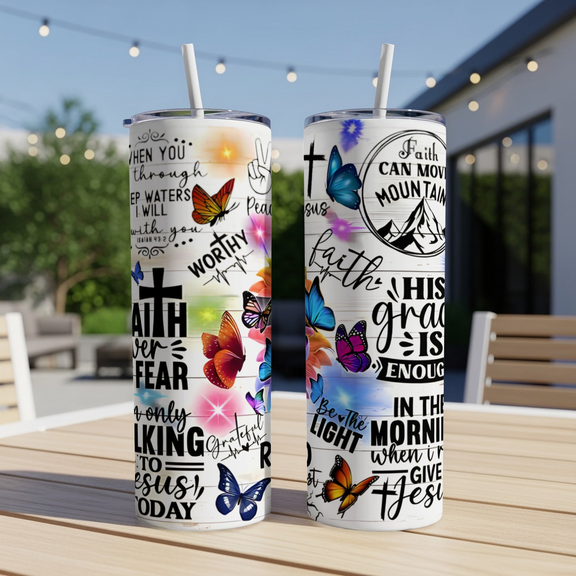 Two tumblers with religious quotes and butterfly designs.