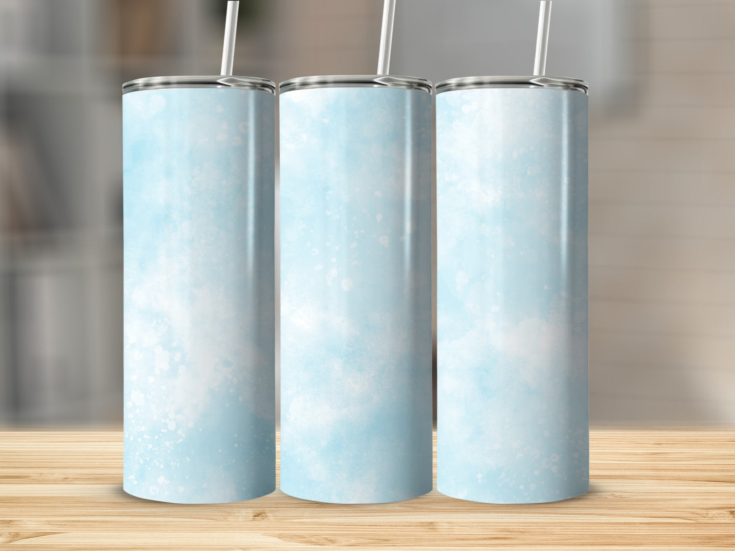 Three tumblers with a light blue watercolor design and white specks.