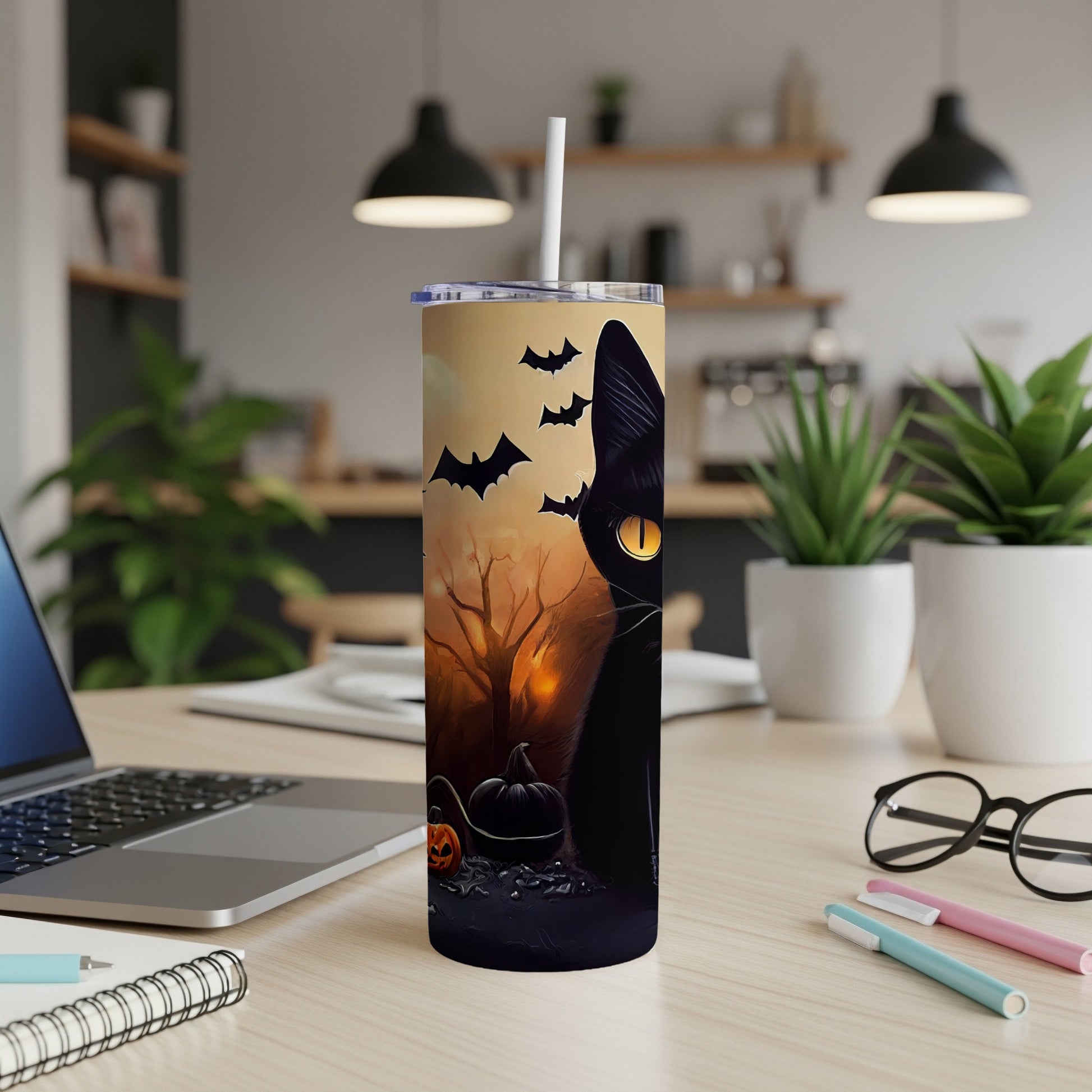 Tumbler with black cat, pumpkins, and bats against a Halloween scene.