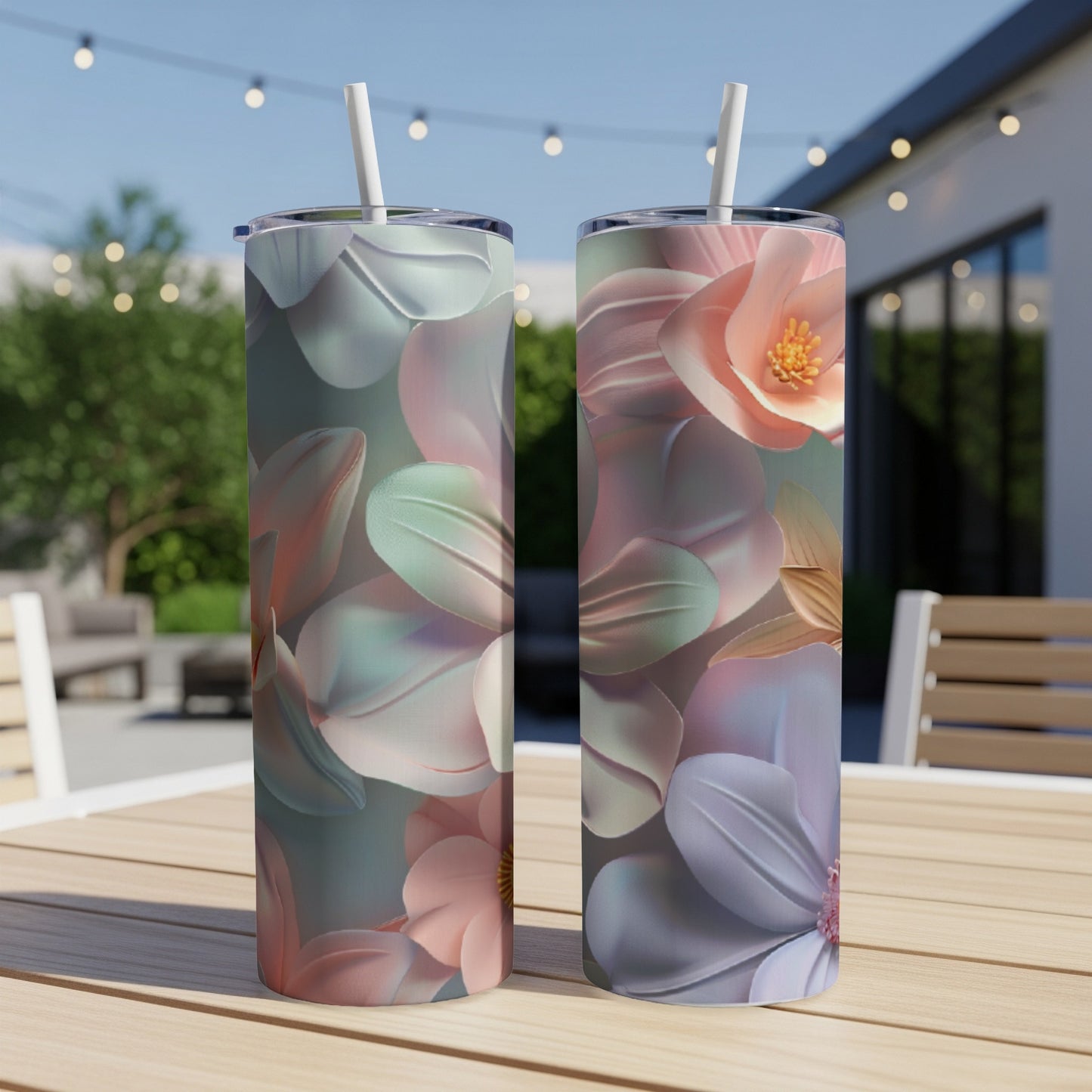 Two tumblers with pastel floral designs on a wooden table.