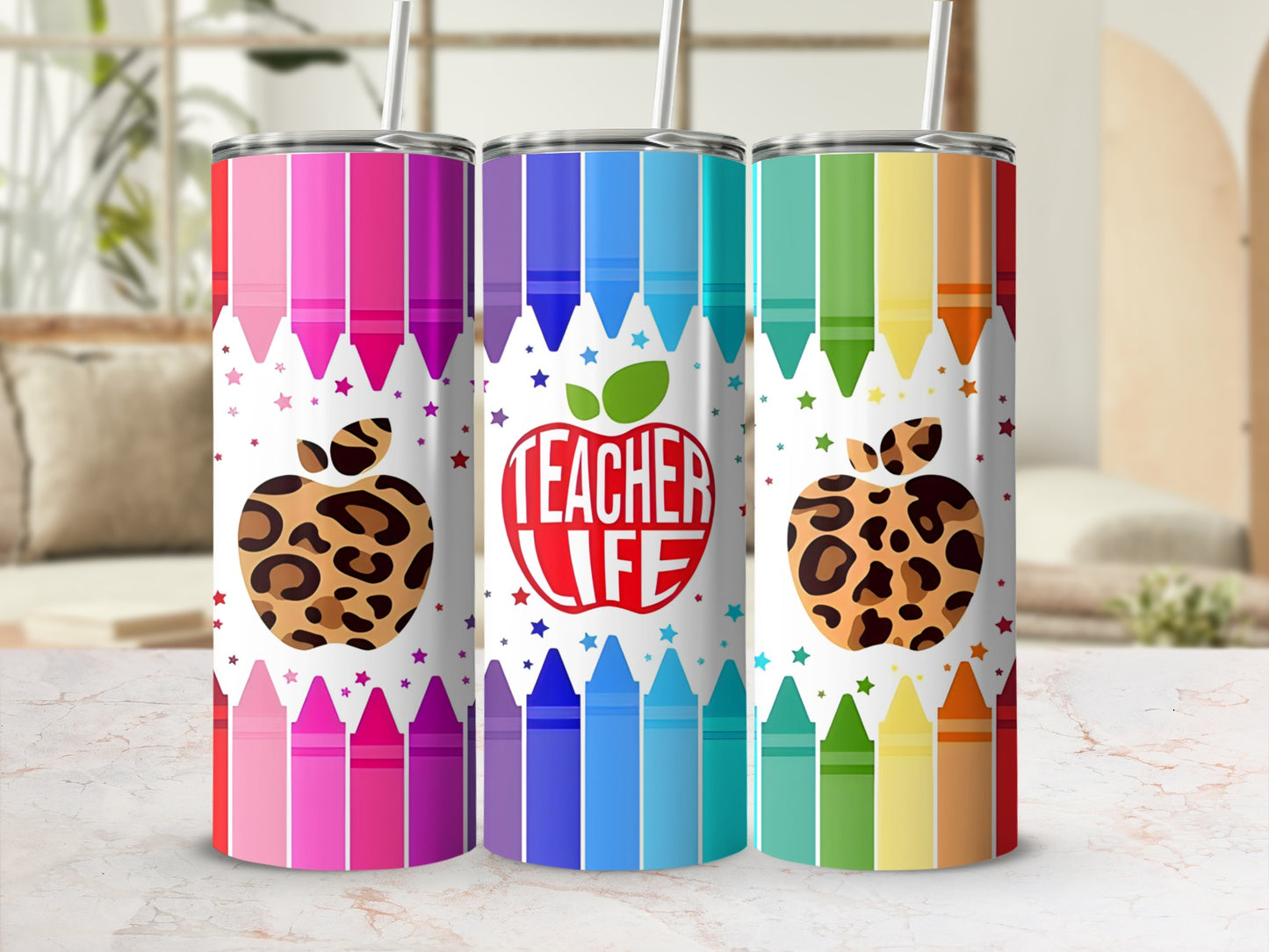 Three colorful teacher-themed tumblers with crayon and apple designs.