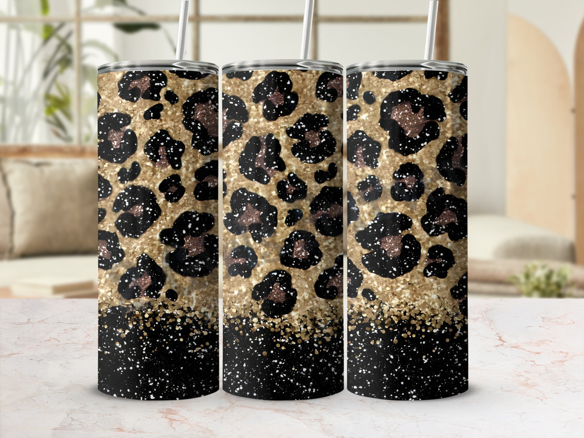 Three tumblers with leopard print and gold glitter designs.
