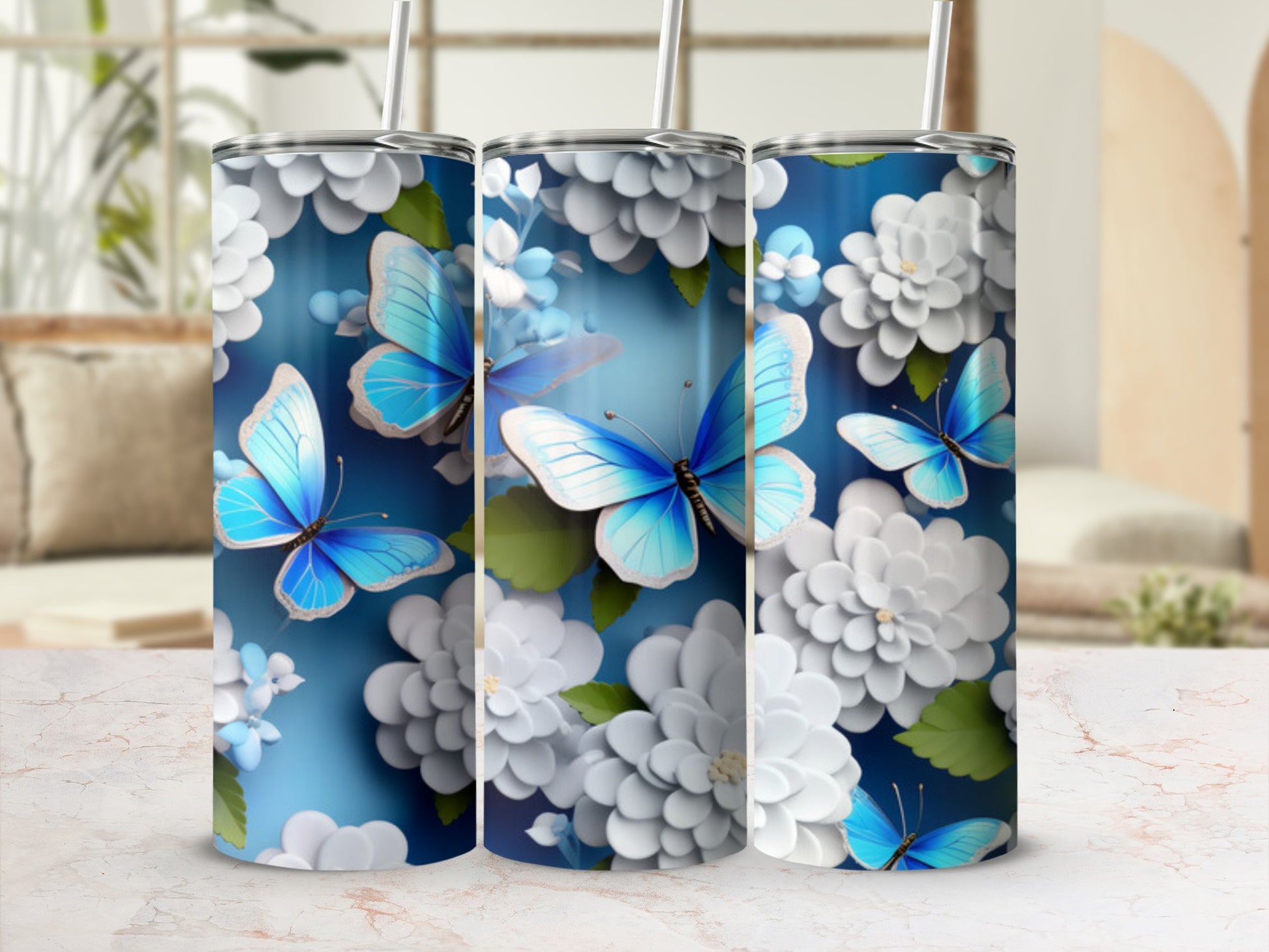 Blue butterflies and white flowers adorn a silver tumbler with straw.