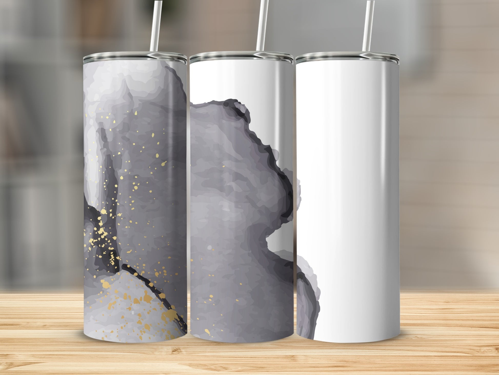 Three blank white tumblers with abstract gray and gold watercolor designs.