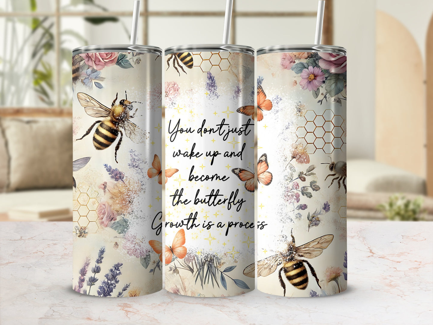 Floral tumbler with bees, butterflies, and motivational quote.