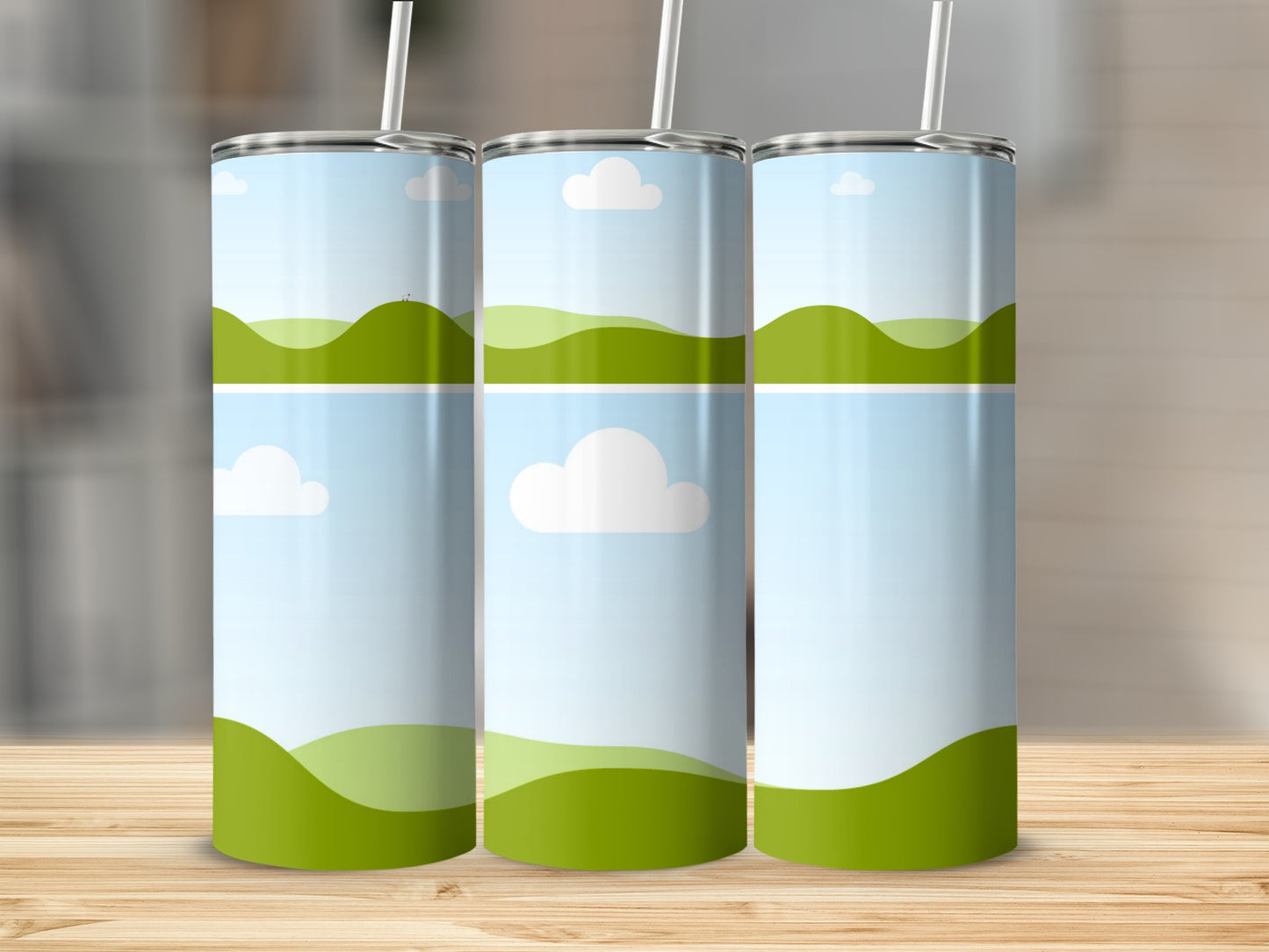 Three tumblers with a green rolling hills and blue sky design.