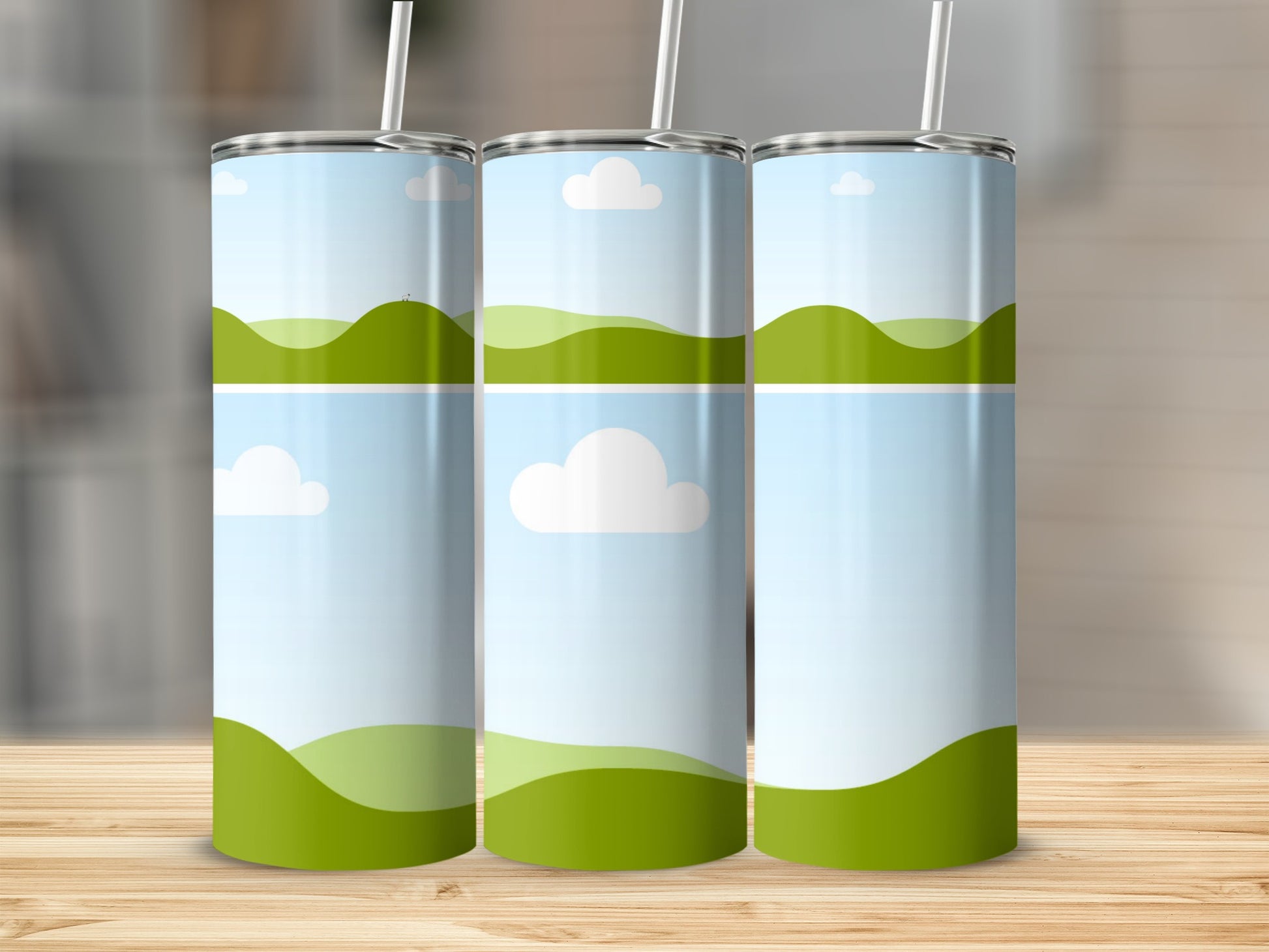 Three tumblers with a green rolling hills and blue sky design.