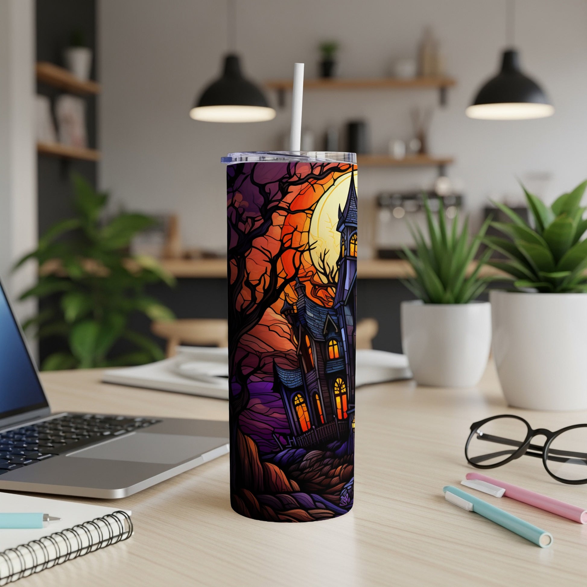 Halloween tumbler with haunted house, moon, and spooky trees.