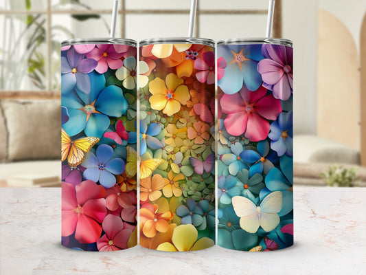 Three colorful tumblers with floral and butterfly designs.