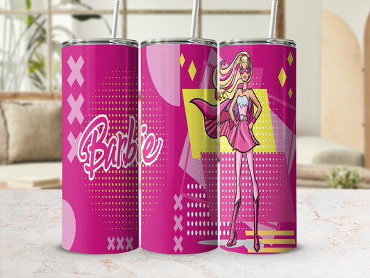 Pink Barbie tumbler with superhero Barbie illustration, geometric patterns, and straw.