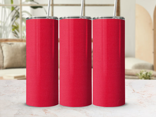 Three red stainless steel tumblers with straws sit on a marble surface.