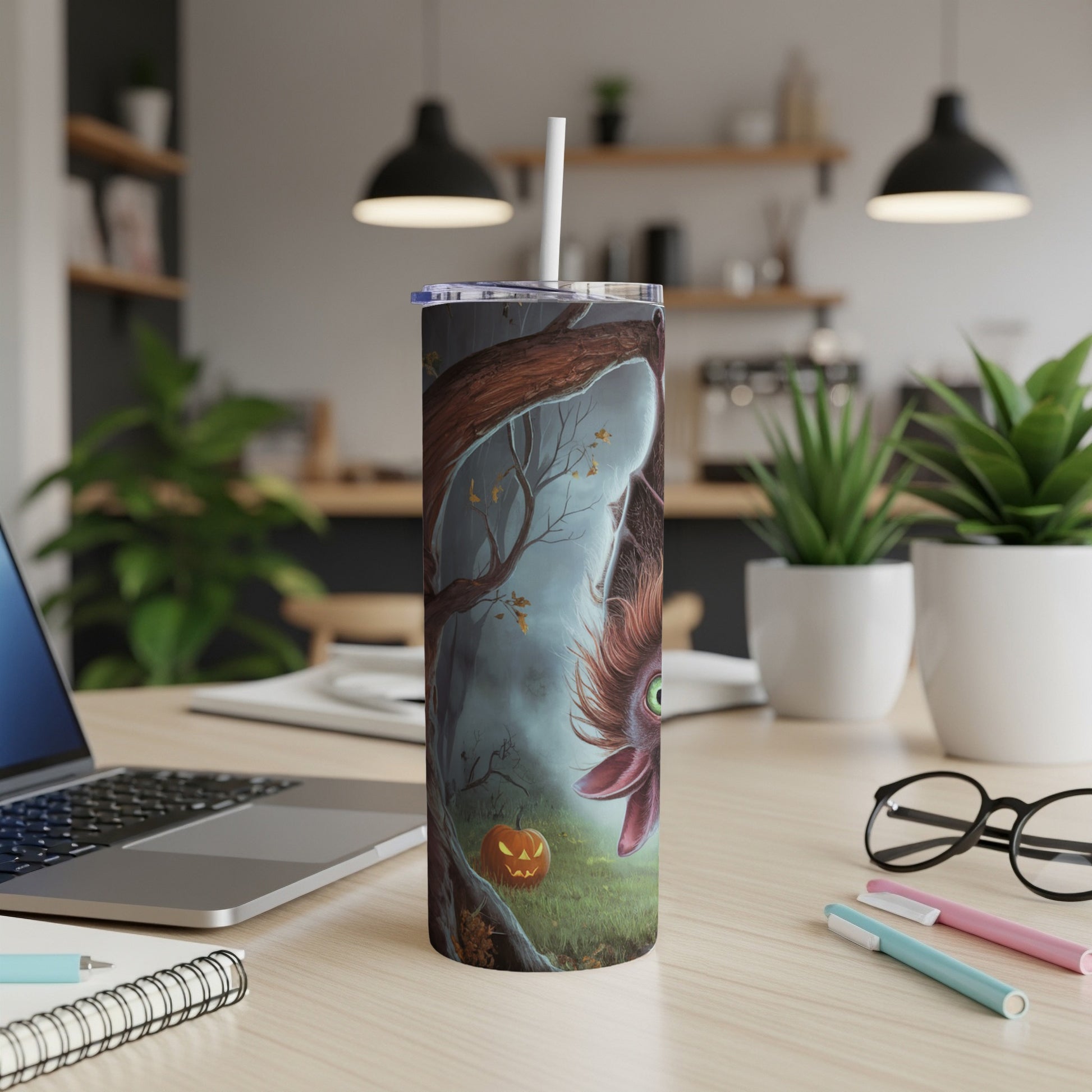 Tumbler with a cartoon bat hanging upside down in a spooky forest with a pumpkin.