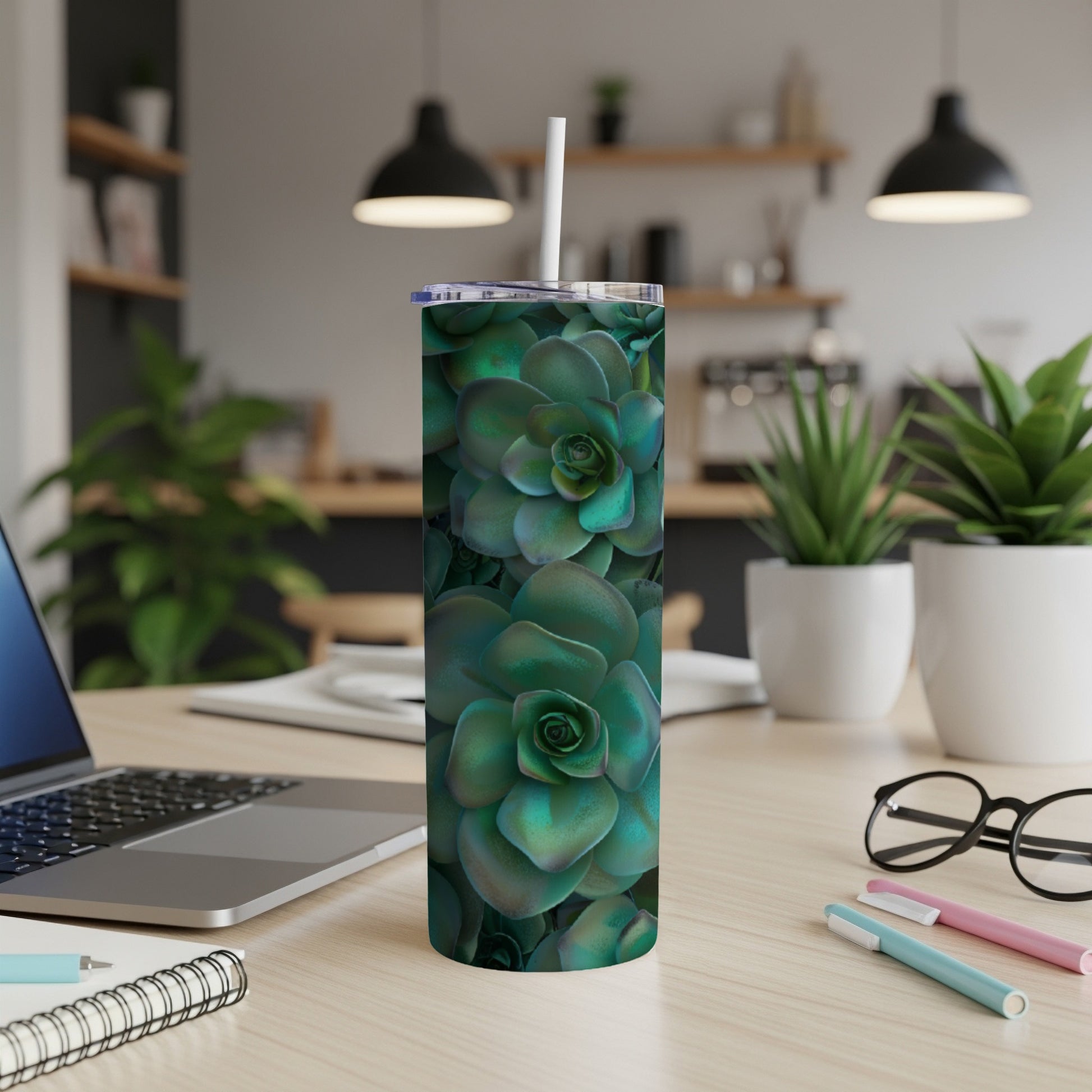 Green succulent pattern on a white insulated tumbler with a straw.