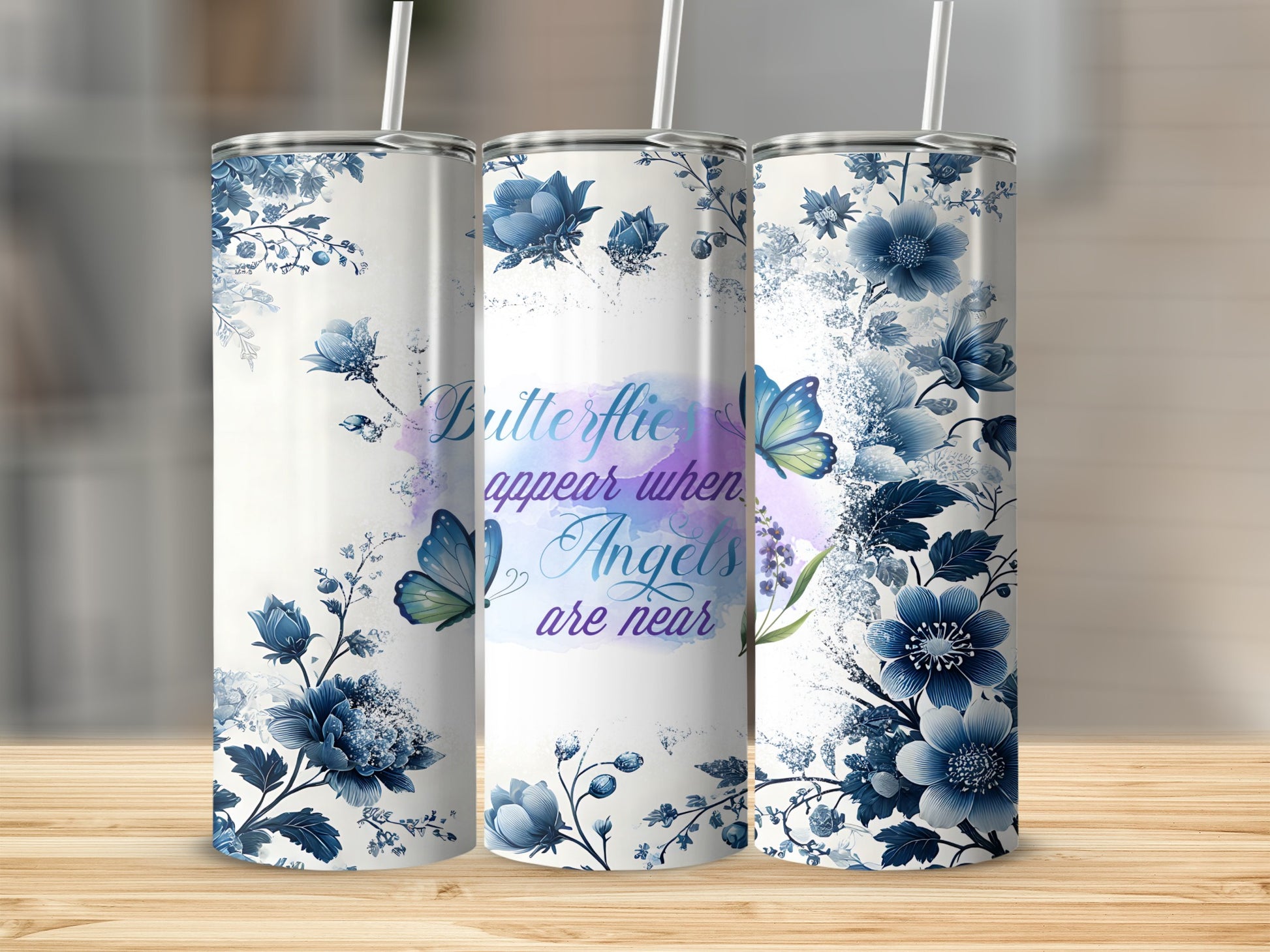 White tumbler with blue floral design and text "Butterflies appear when Angels are near."