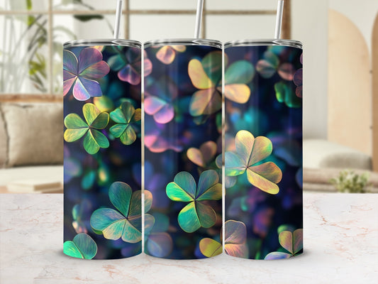 Three iridescent shamrock patterned tumblers with straws on a marble surface.