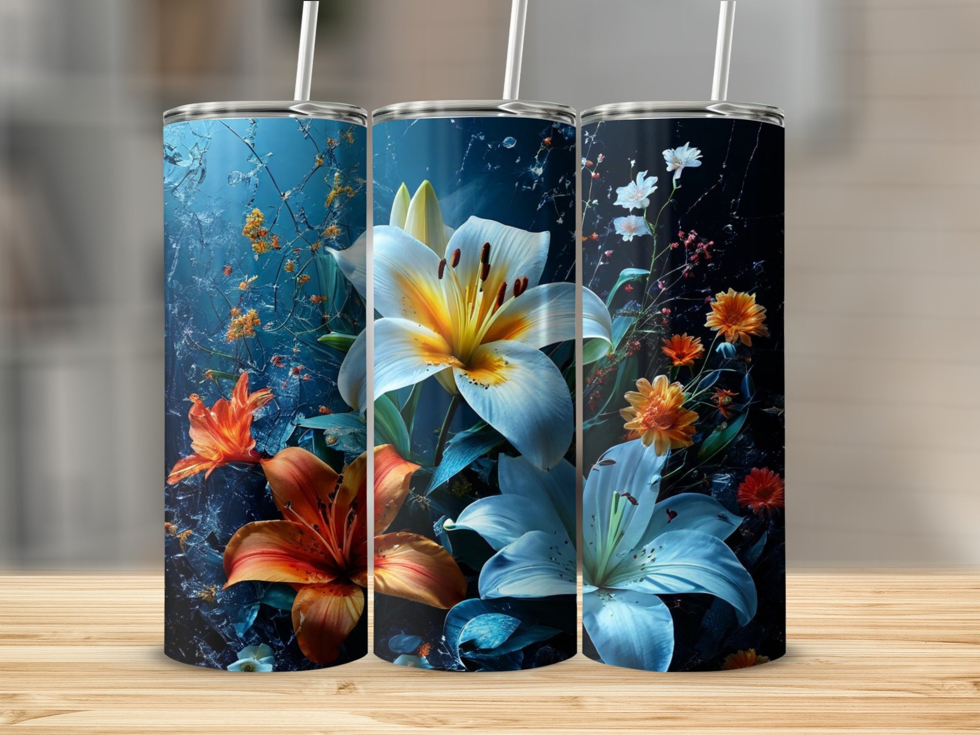 Three tumblers with vibrant lily designs against a dark, textured background.