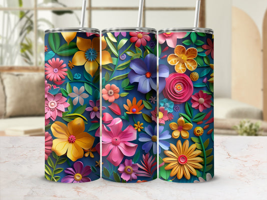 Three floral-patterned tumblers with straws stand on a marble surface.