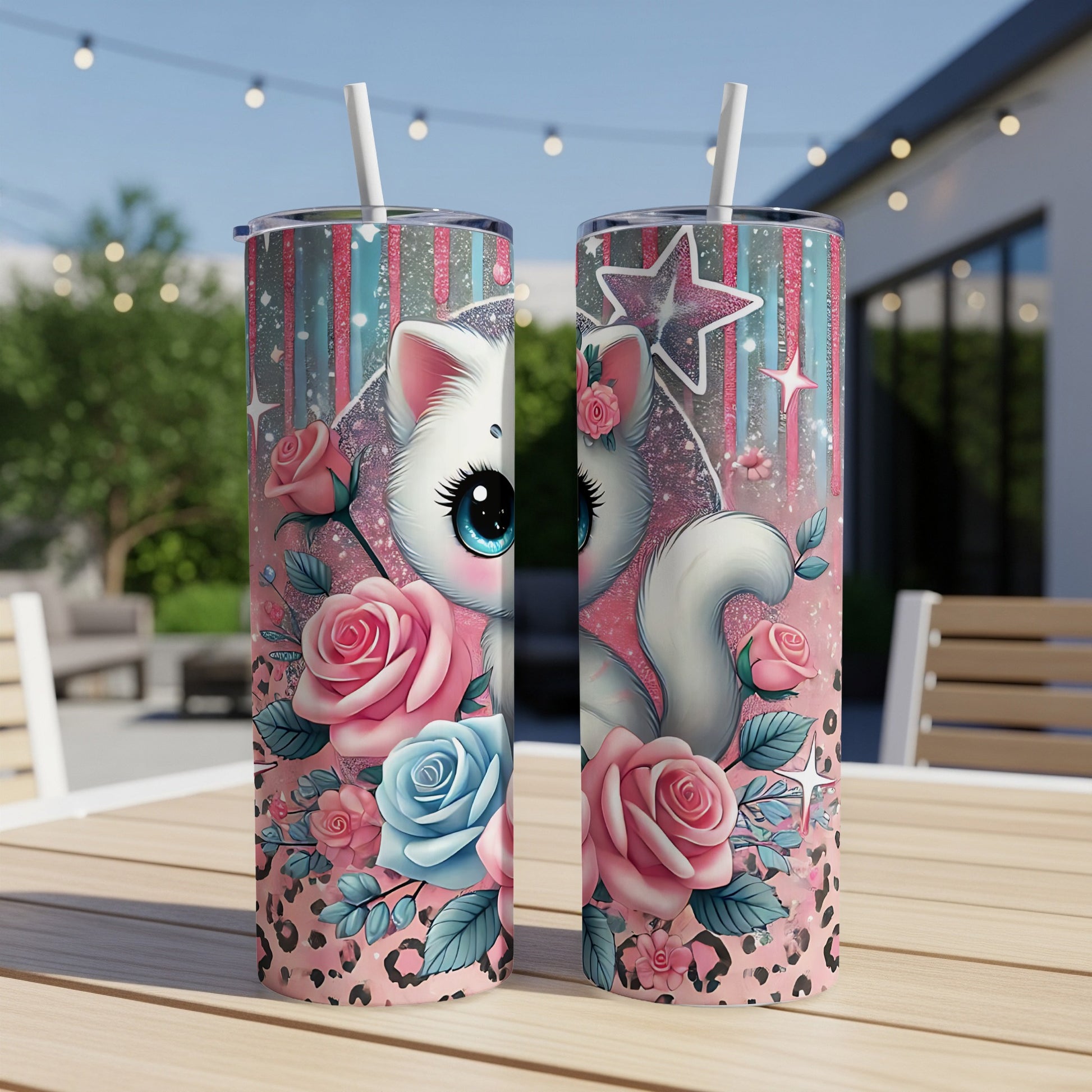 White cat with big blue eyes, surrounded by pink and blue roses, on a patterned tumbler.