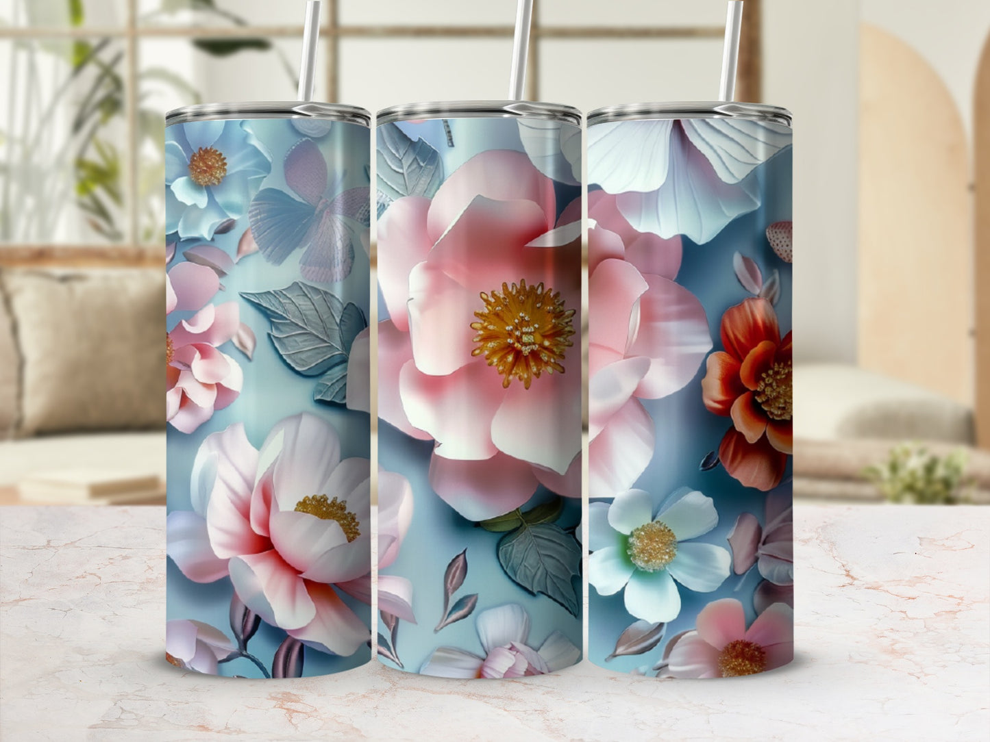 Three floral patterned tumblers with pink and white flowers and green leaves.
