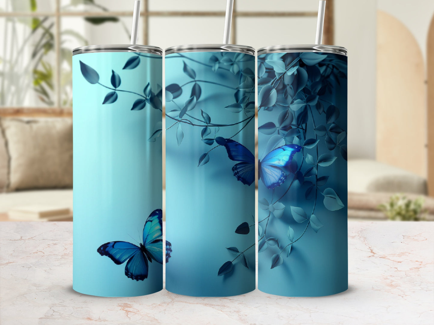 Three teal tumblers with blue butterflies and foliage.