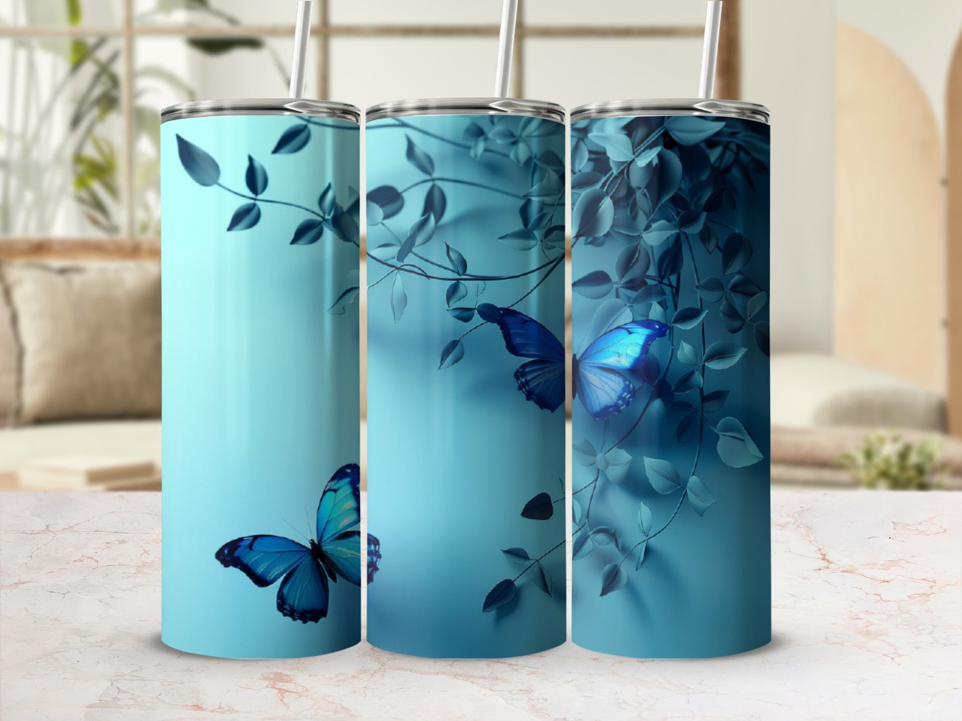 Three teal tumblers with blue butterflies and foliage.