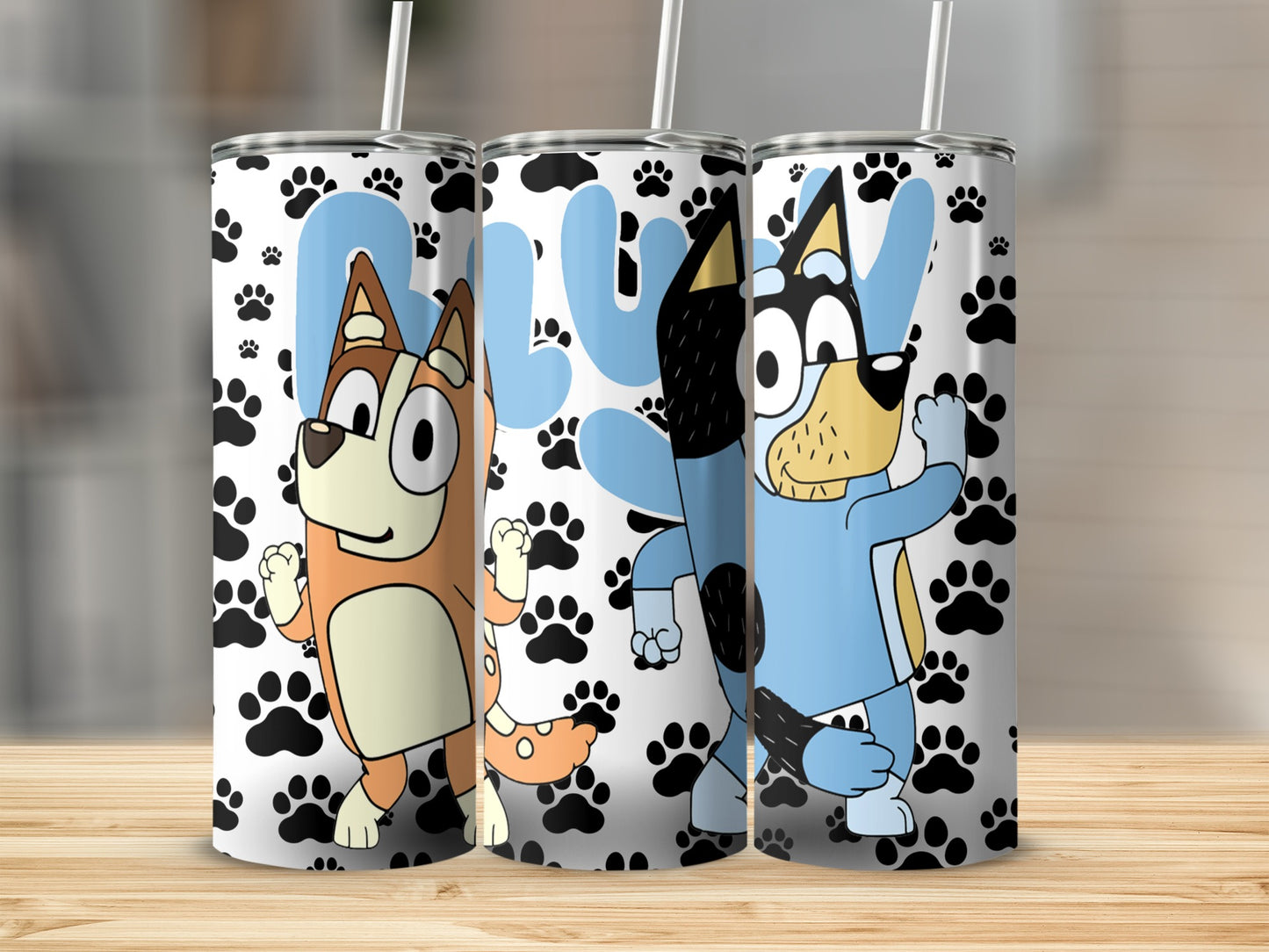Three Bluey characters on a tumbler with paw print background.