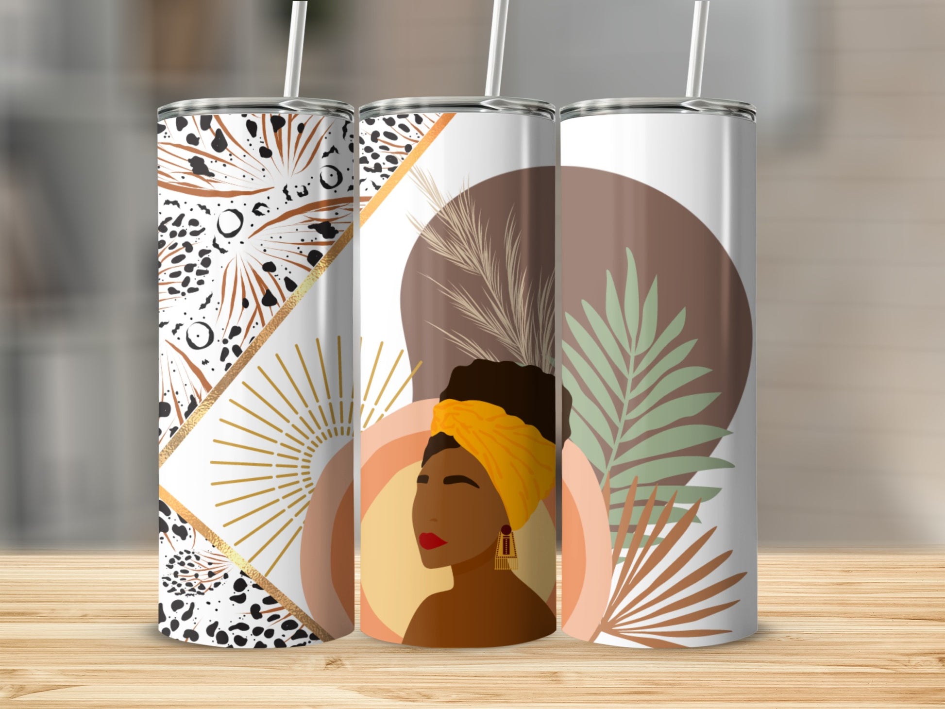 Three tumblers with abstract designs featuring a woman and gold accents.